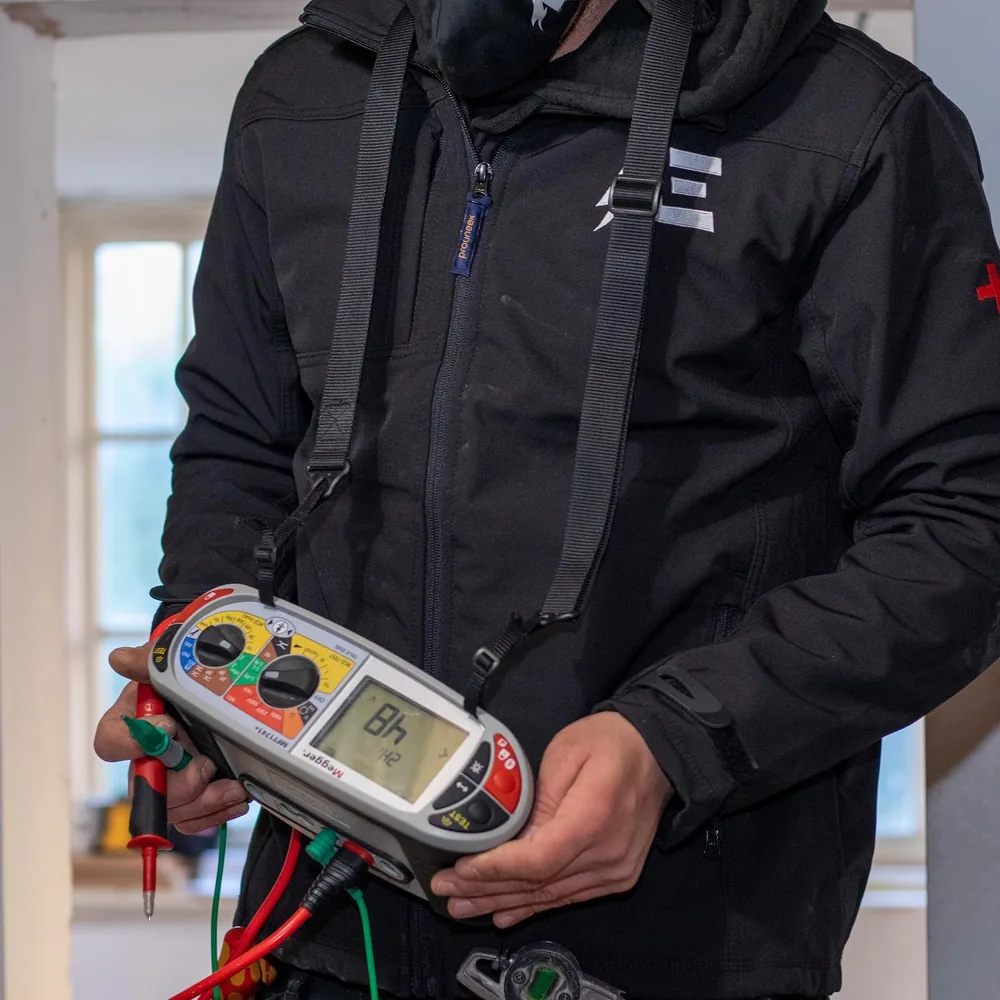 A Electric Solutions electrician testing a circuit with a Megger multifunction tester